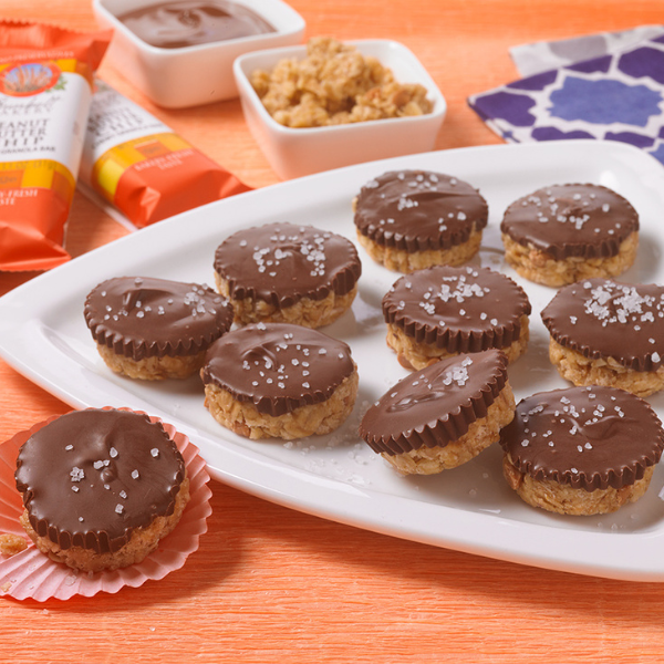 granola peanut butter bites topped with chocolate and sea salt flakes