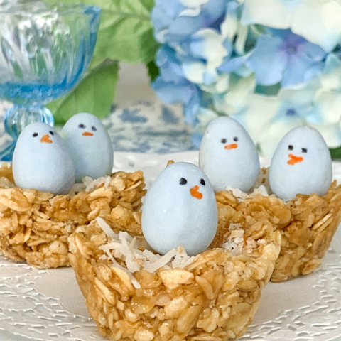 granola bars shaped like bird nests with blue candies decorated like baby chicks for spring