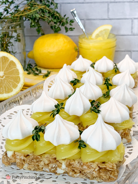 lemon meringue bars topped with lemon curd and meringue cookies