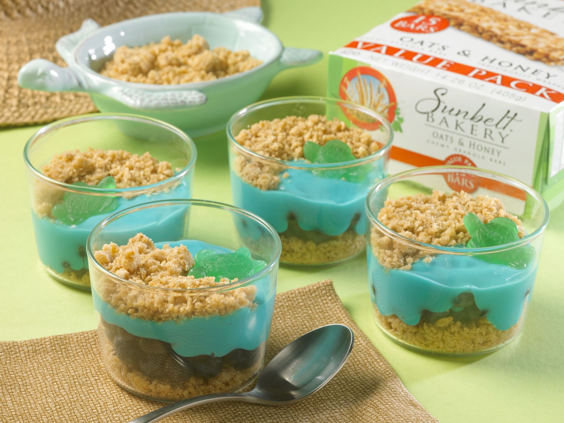 beach themed parfaits layered with granola, blue colored yogurt and a turtle gummy