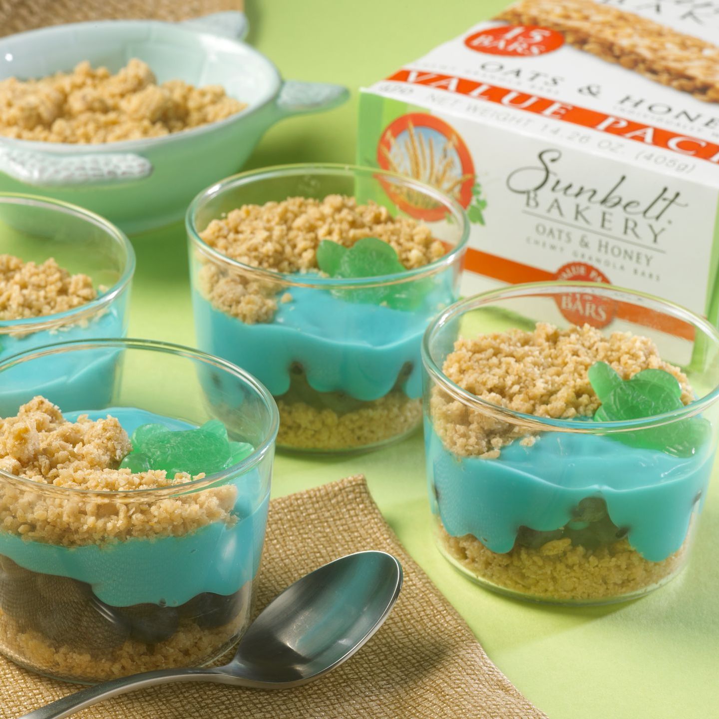 beach themed parfaits layered with granola, blue colored yogurt and a turtle gummy