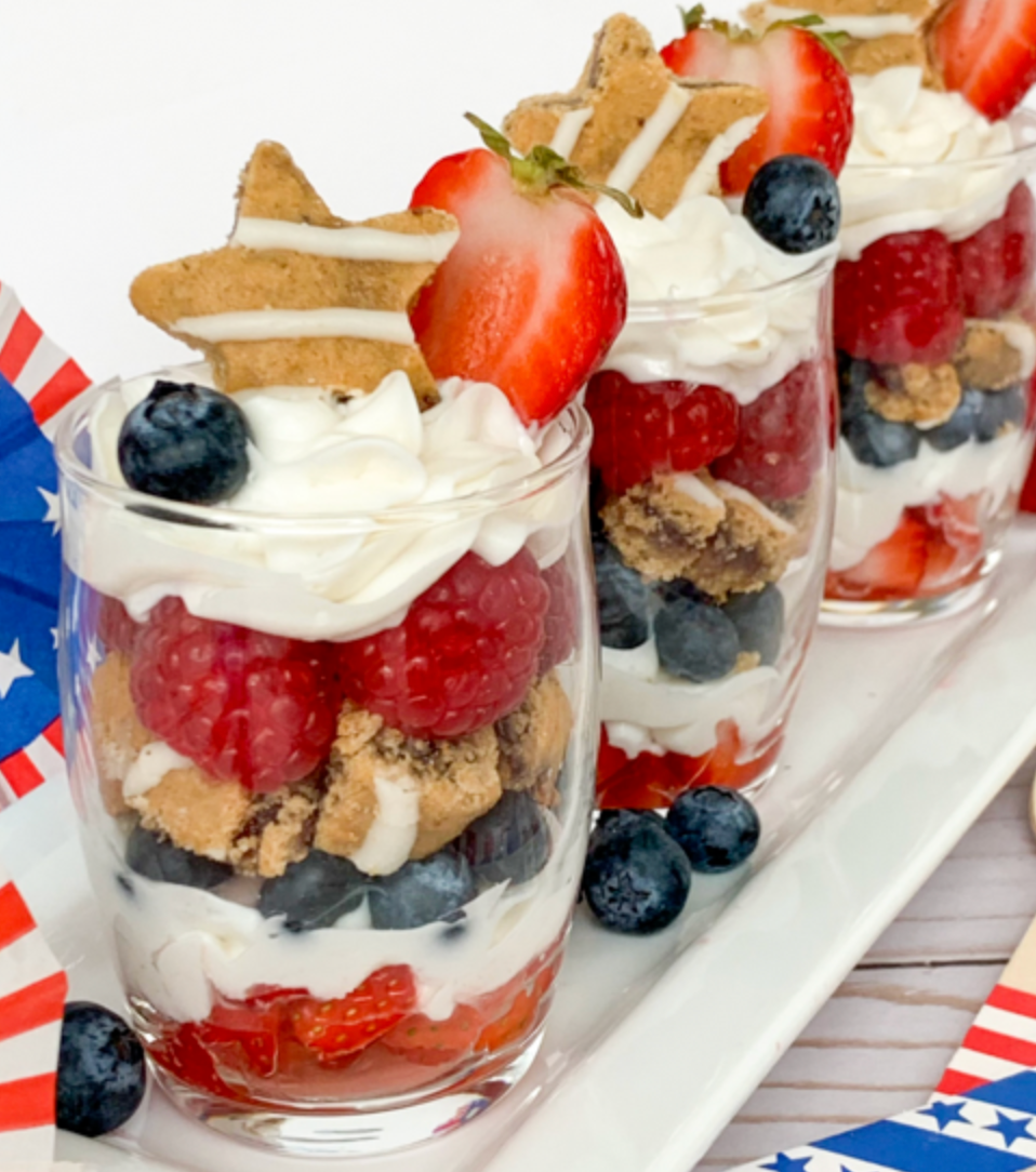 patriotic themed parfaits layered with soft baked bars, yogurt and fresh fruit in tall glasses