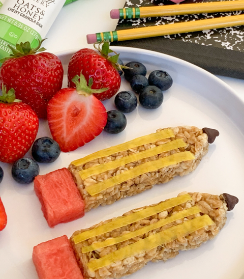 granola bar shaped like a pencil and decorated as a pencil with fresh fruit 