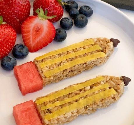 granola bar shaped like a pencil and decorated as a pencil with fresh fruit