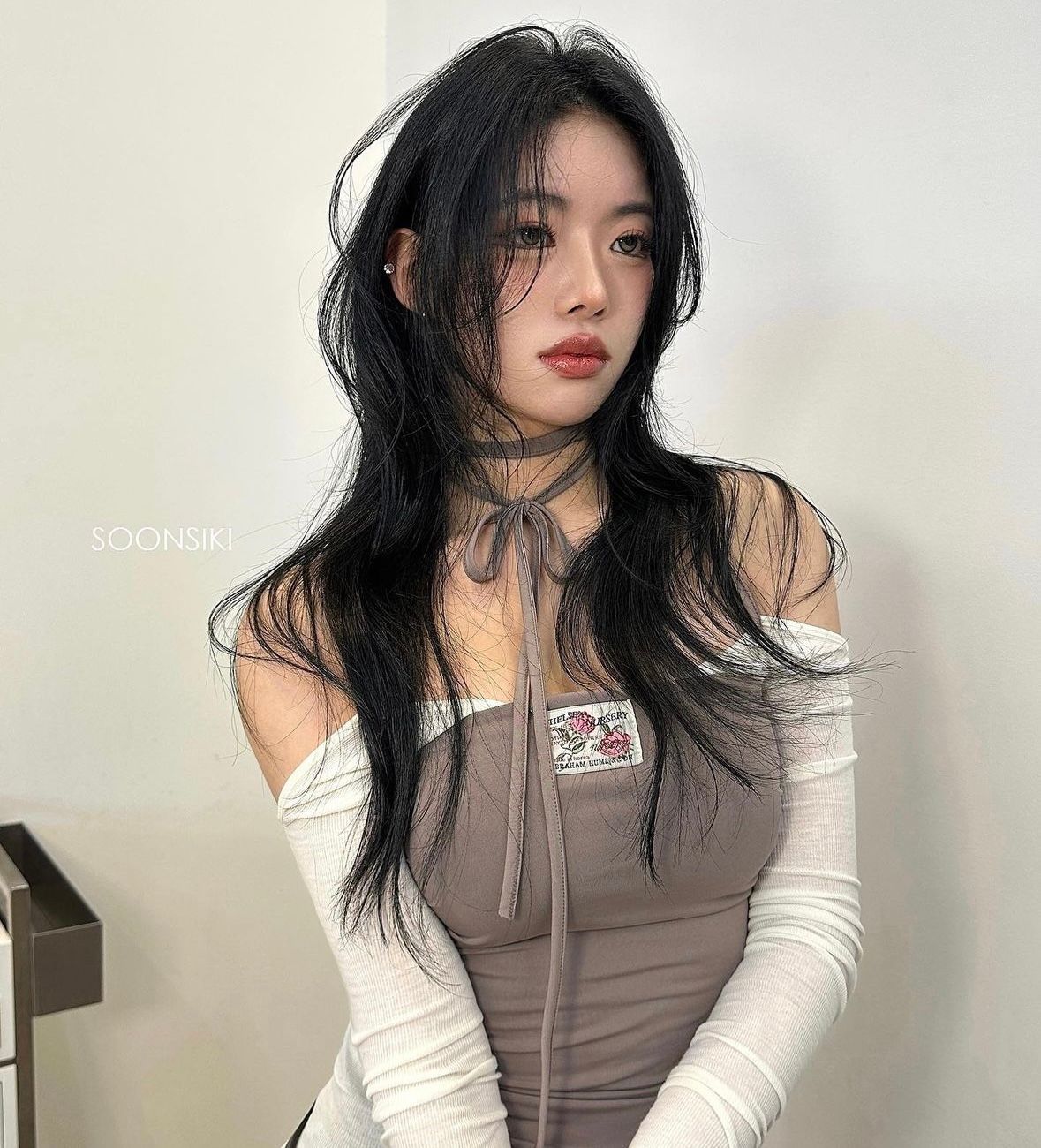 Black wavy personalized design perm with bangs at Soonsiki Moment Hongdae, Seoul