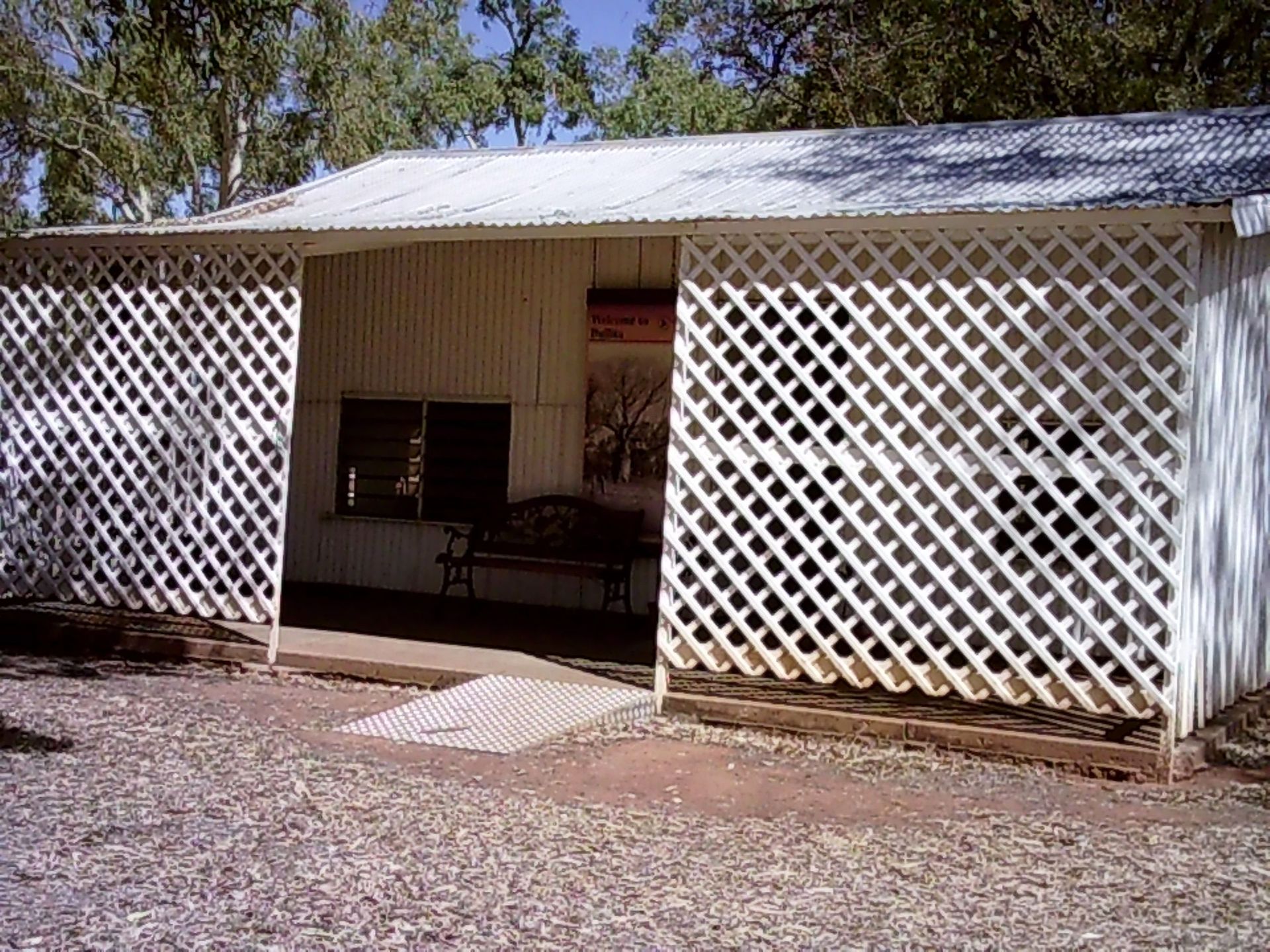 A white house with a lattice fence around it