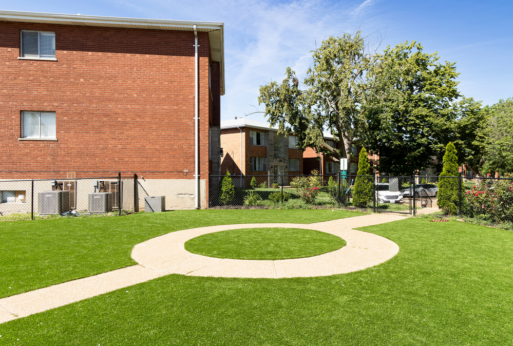 A brick building with a circular walkway in front of it.