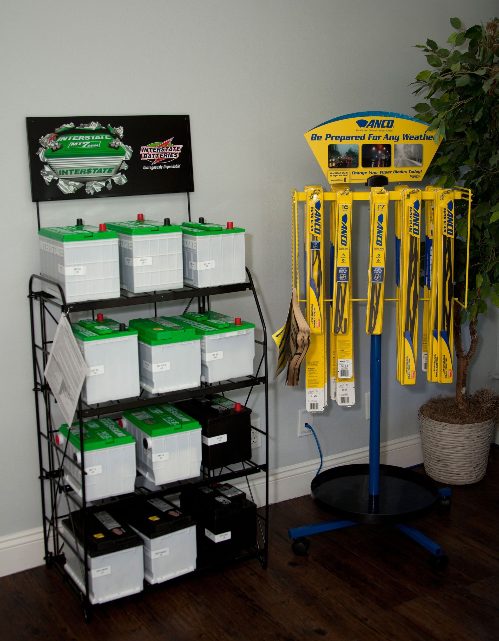 Retail display of green-and-white products beside a blue stand of yellow-packaged items in a store corner