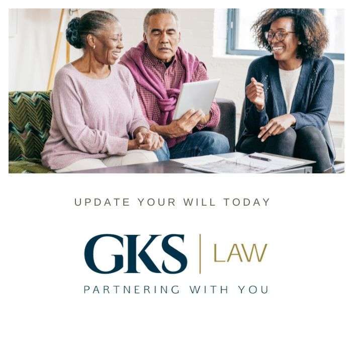 A couple looking over paperwork with the GKS Law logo