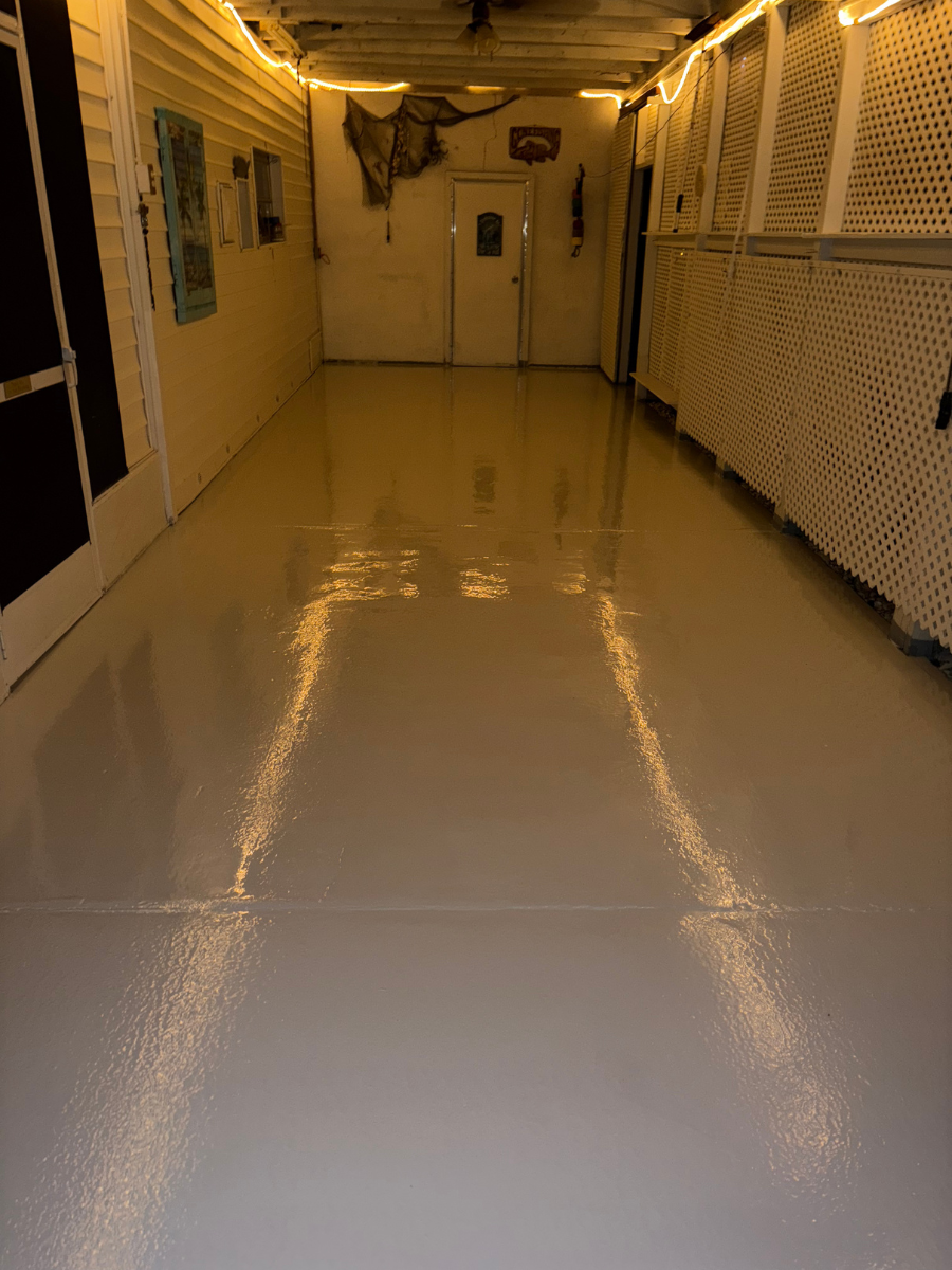 A polished, glossy white floor reflects warm lighting in a hallway with white walls and lattice paneling on the right.