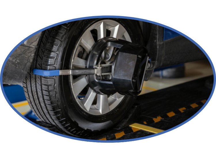 Close-up of a car wheel secured on a blue wheel alignment machine