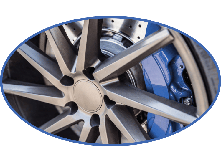 Close-up of a silver car wheel with blue brake caliper visible behind the spokes