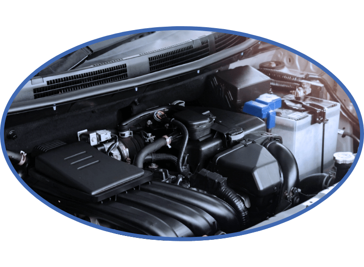 Car engine bay with black components and a blue battery on the right