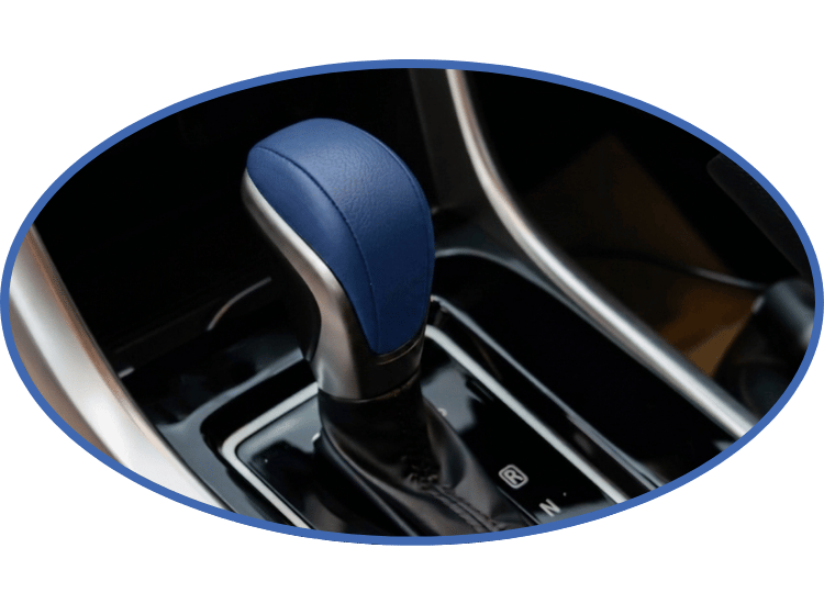 Blue gear shift lever in a car’s center console, with black trim and silver accents.