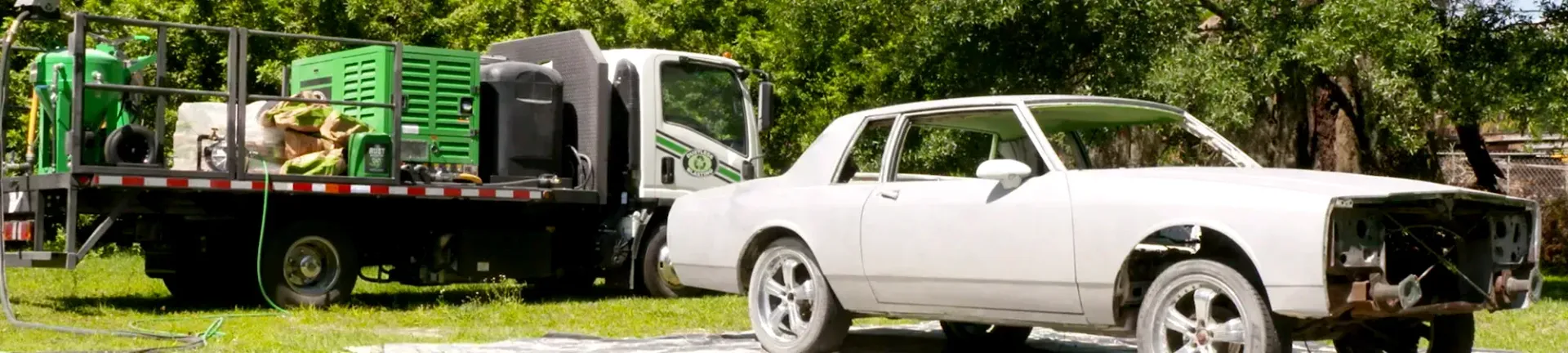 Contact Us A white car is parked next to a tow truck.ontact Lyons!