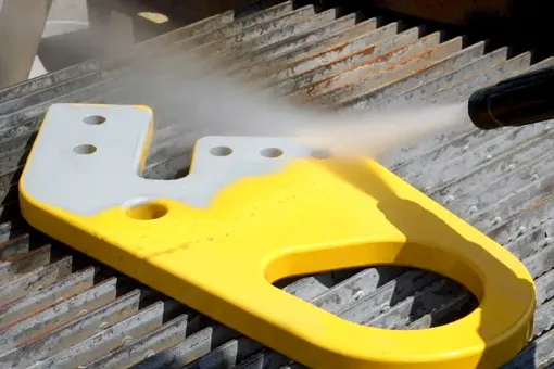 Contact Us A yellow and white object is being sprayed with a high pressure washer.