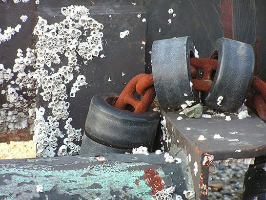 A close up of a tire with a chain attached to it