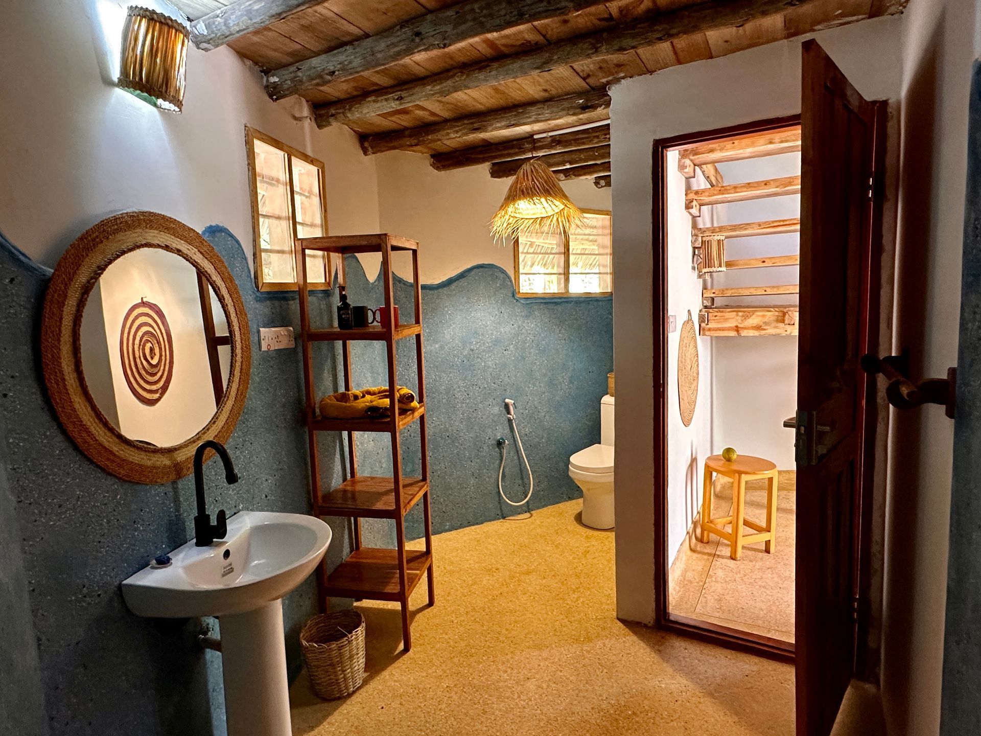 A bathroom with a sink , toilet and mirror.