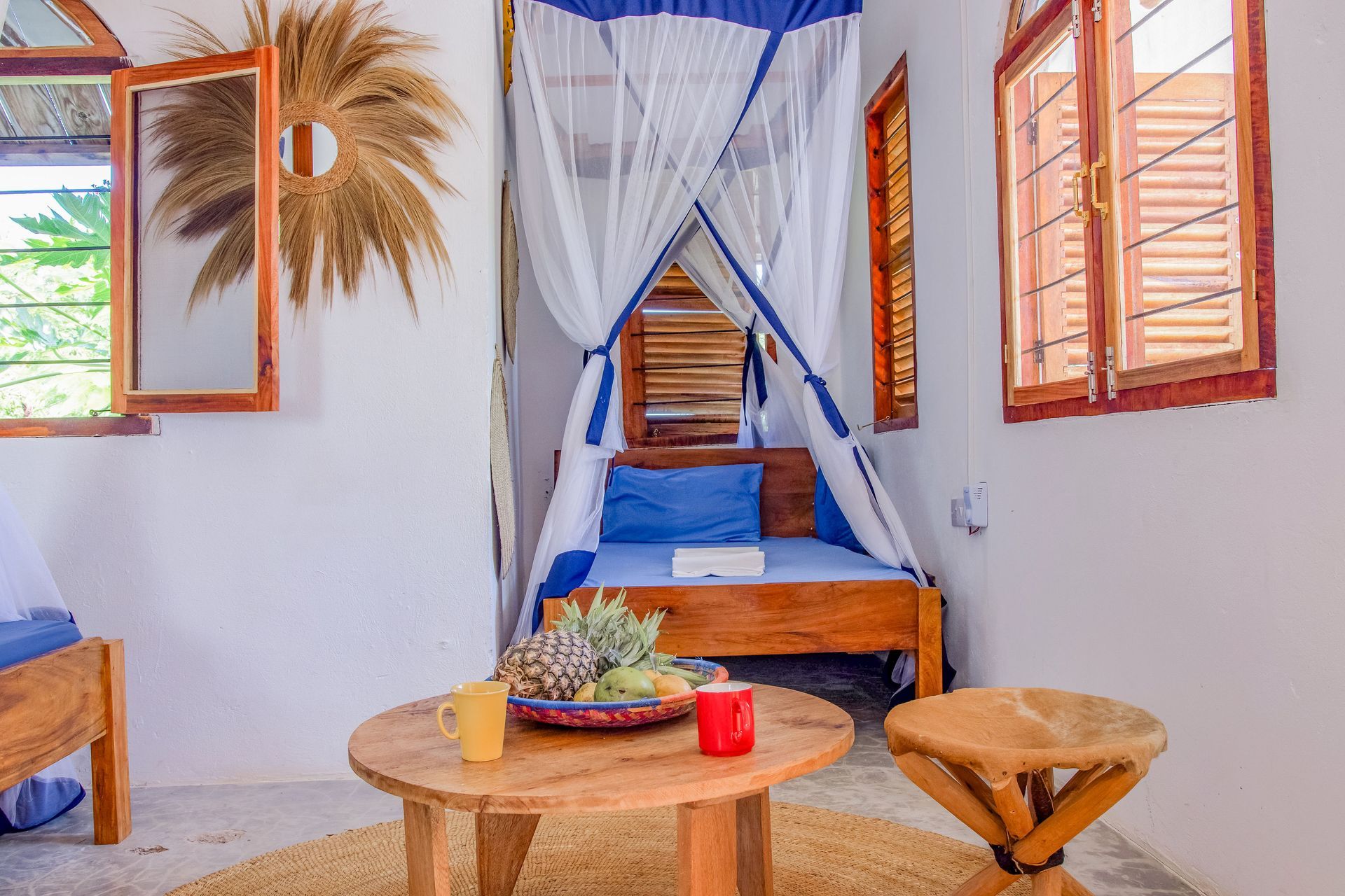 Bedroom for 3 persons, double bed, balcony with tropical garden view, ceiling fan