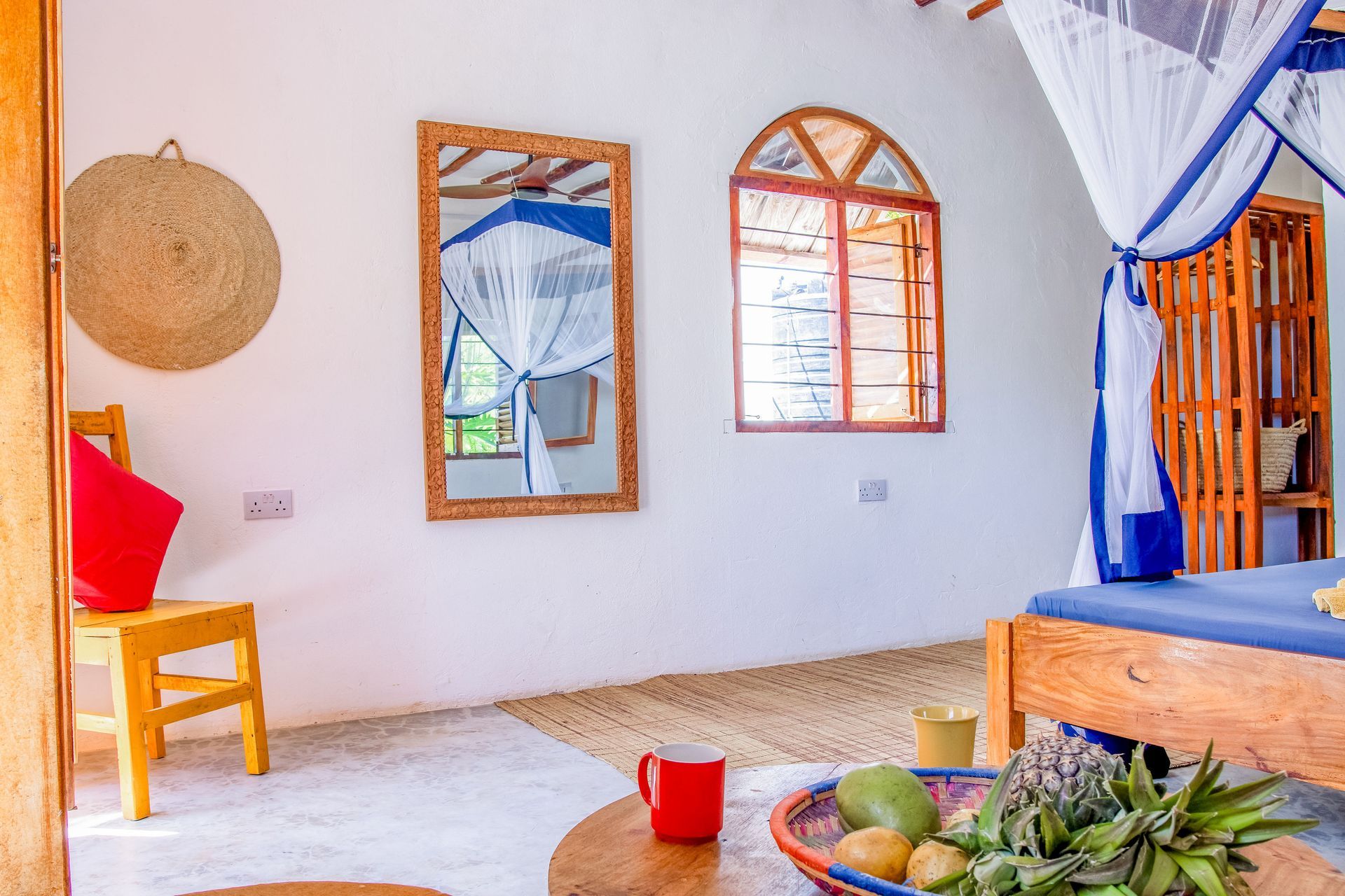 Bedroom for 3 persons, double bed, balcony with tropical garden view, ceiling fan