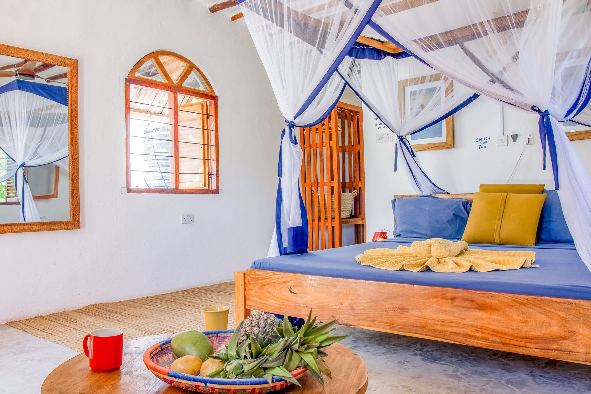 Bedroom for 3 persons, double bed, balcony with tropical garden view, ceiling fan