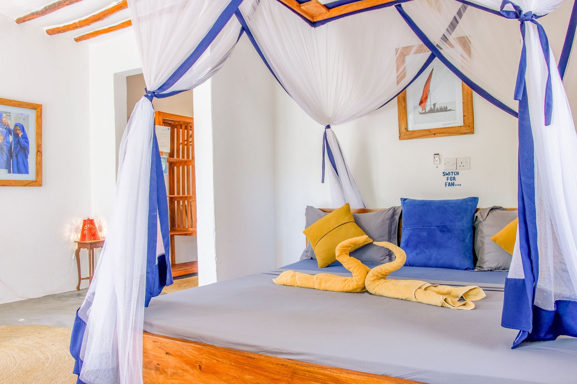 Bedroom for 3 persons, double bed, balcony with tropical garden view, ceiling fan