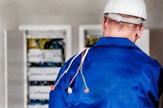 Licensed electrician inspecting circuit breaker — San Diego, CA — White Horse Electric