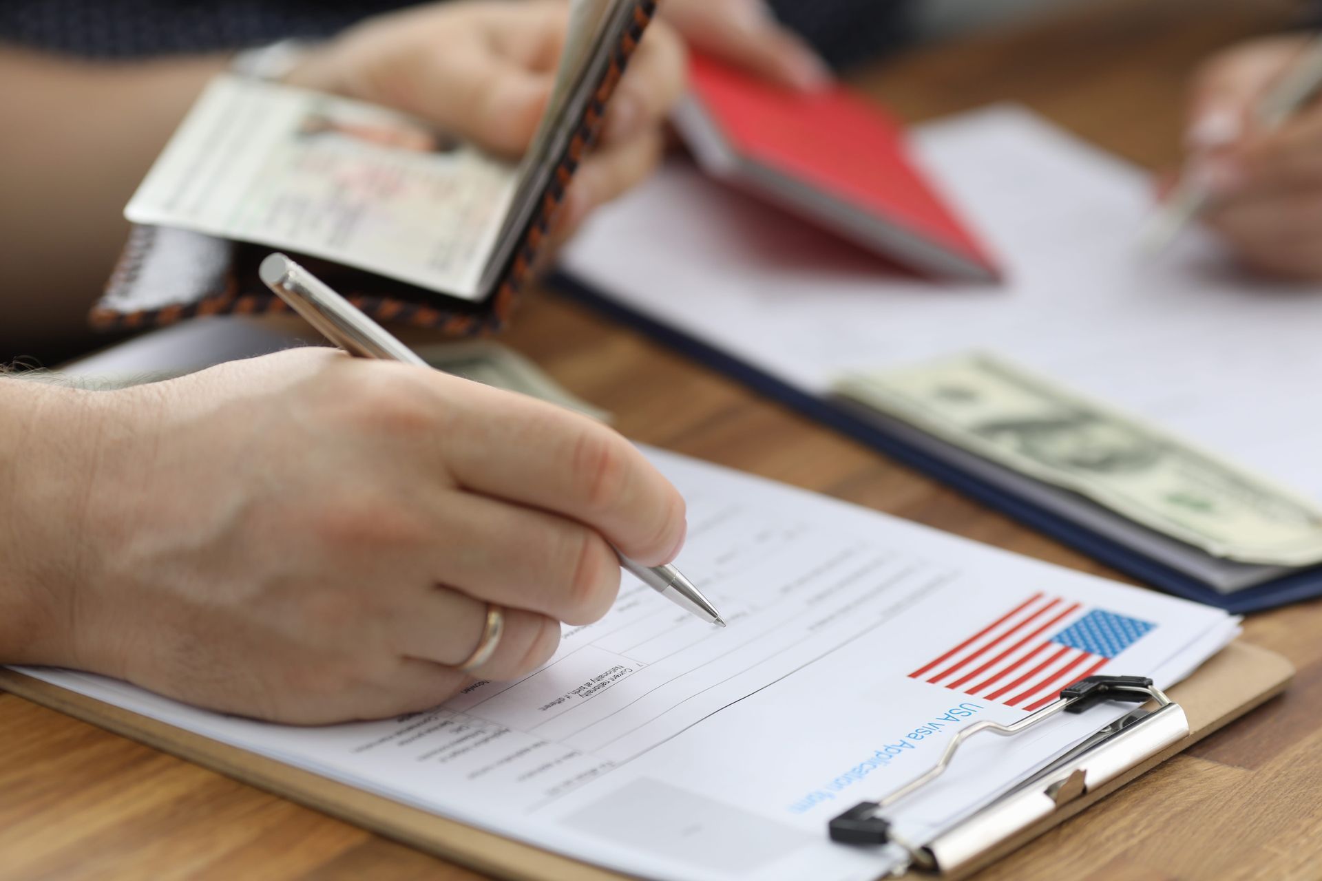 Hand writing on a financial chart beside a calculator and currency notes
