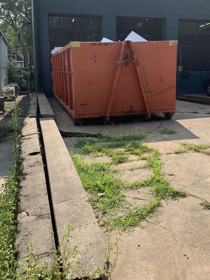 garbage dumpsters in the utility trailer