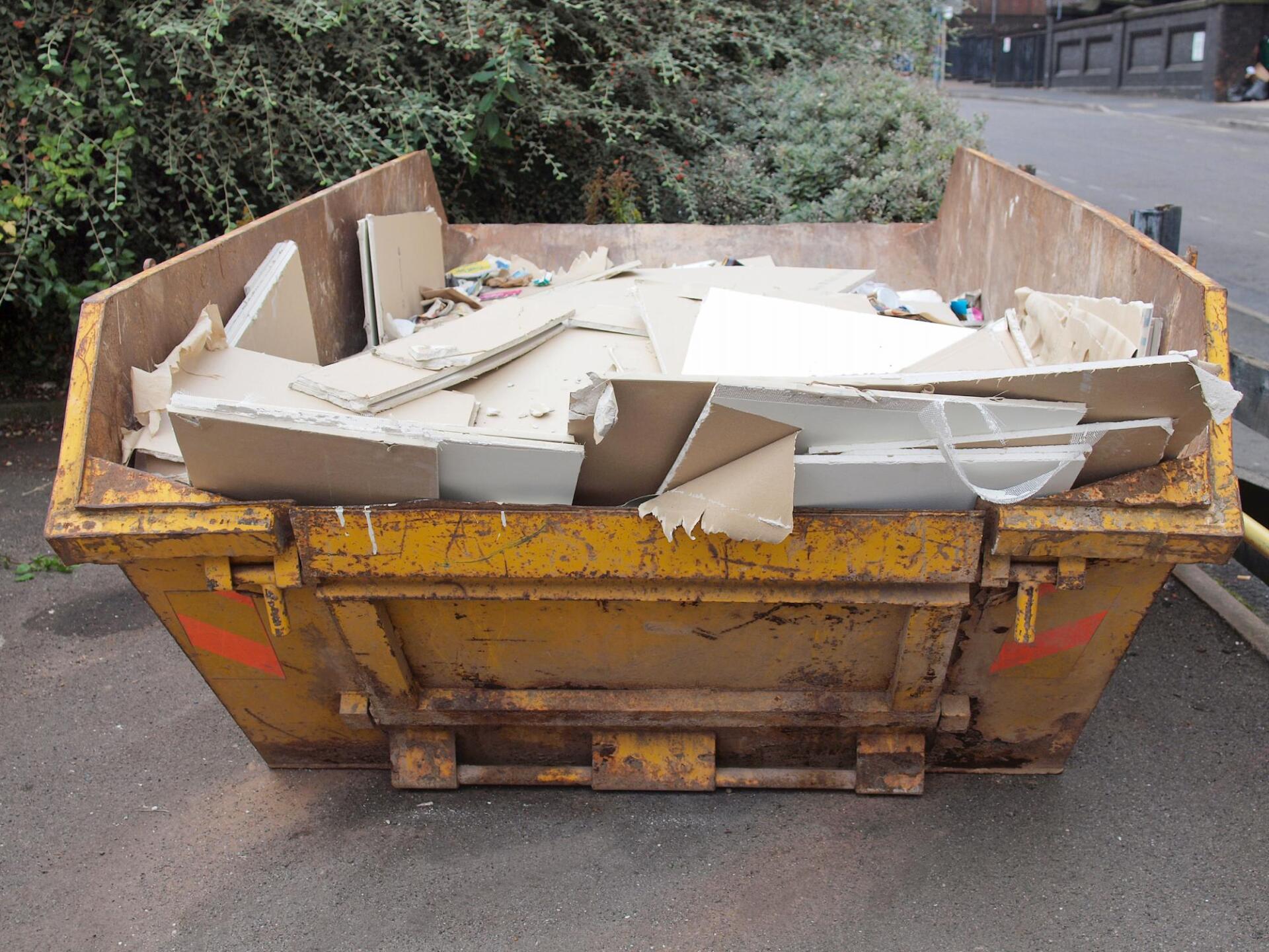 garbage dumpster with construction debris