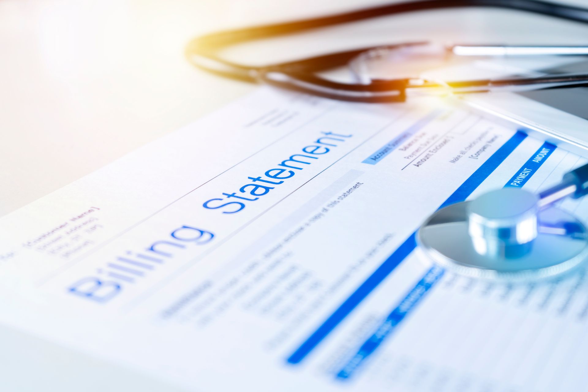 Medical billing statement with a stethoscope and tablet.