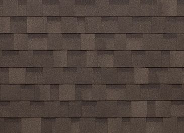 A close up of a roof with brown shingles.
