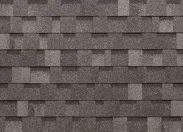 A close up of a row of gray shingles on a roof.