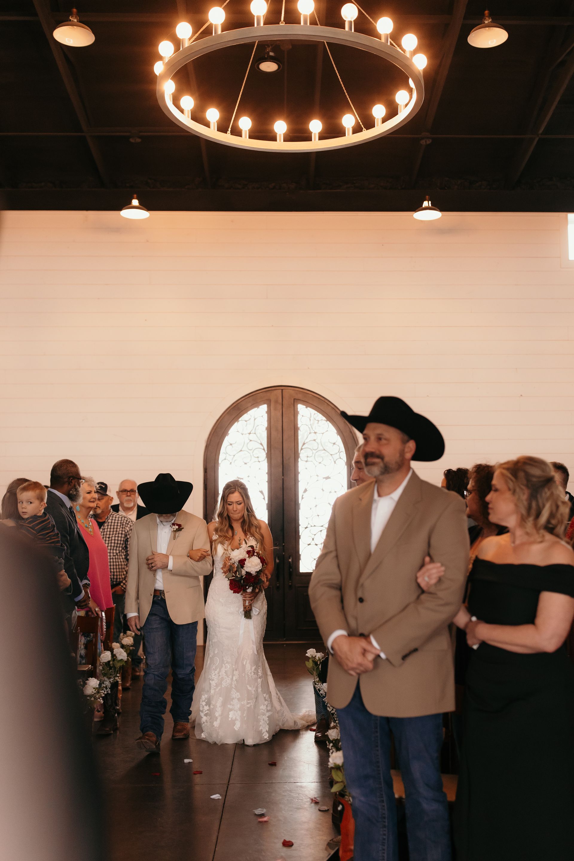 guests looking at bride walking down aisle