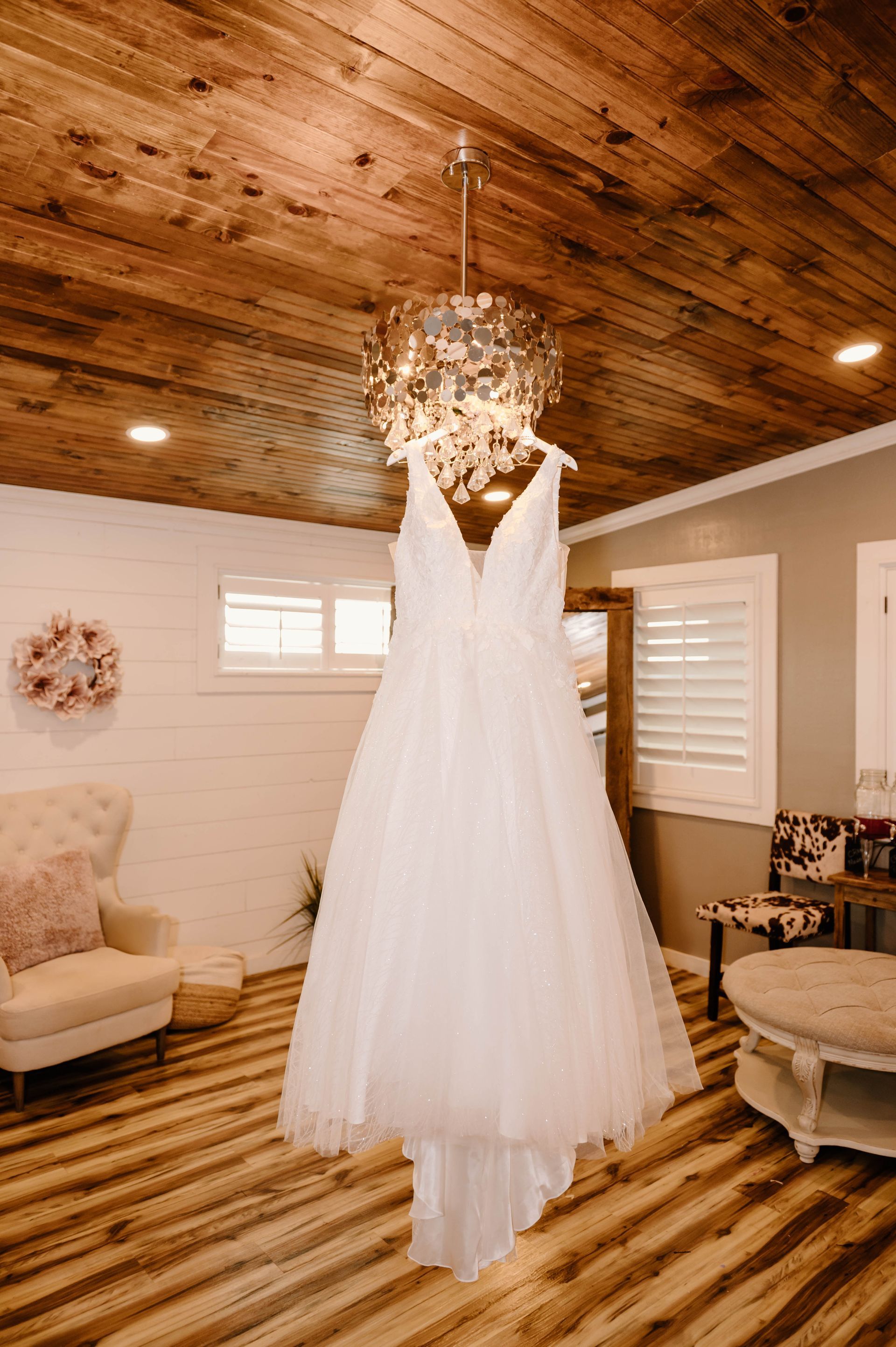 wedding dress hanging from chandelier