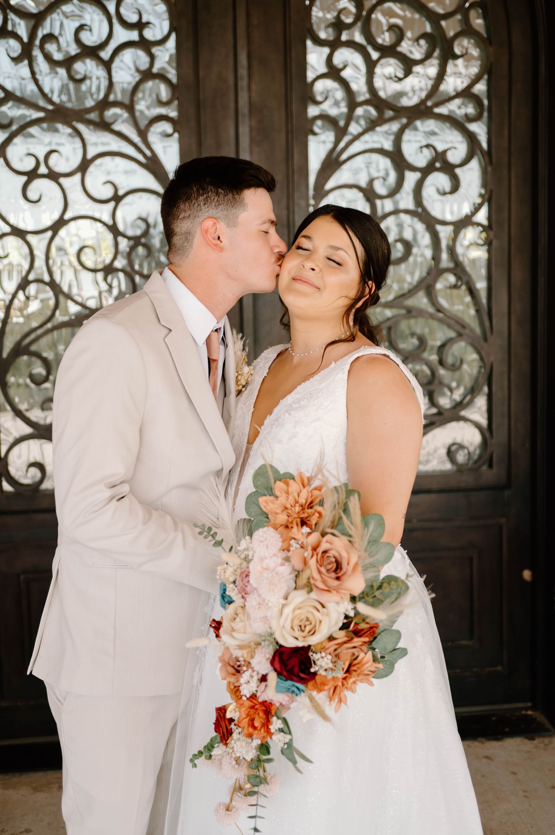 groom kissing bride on cheese