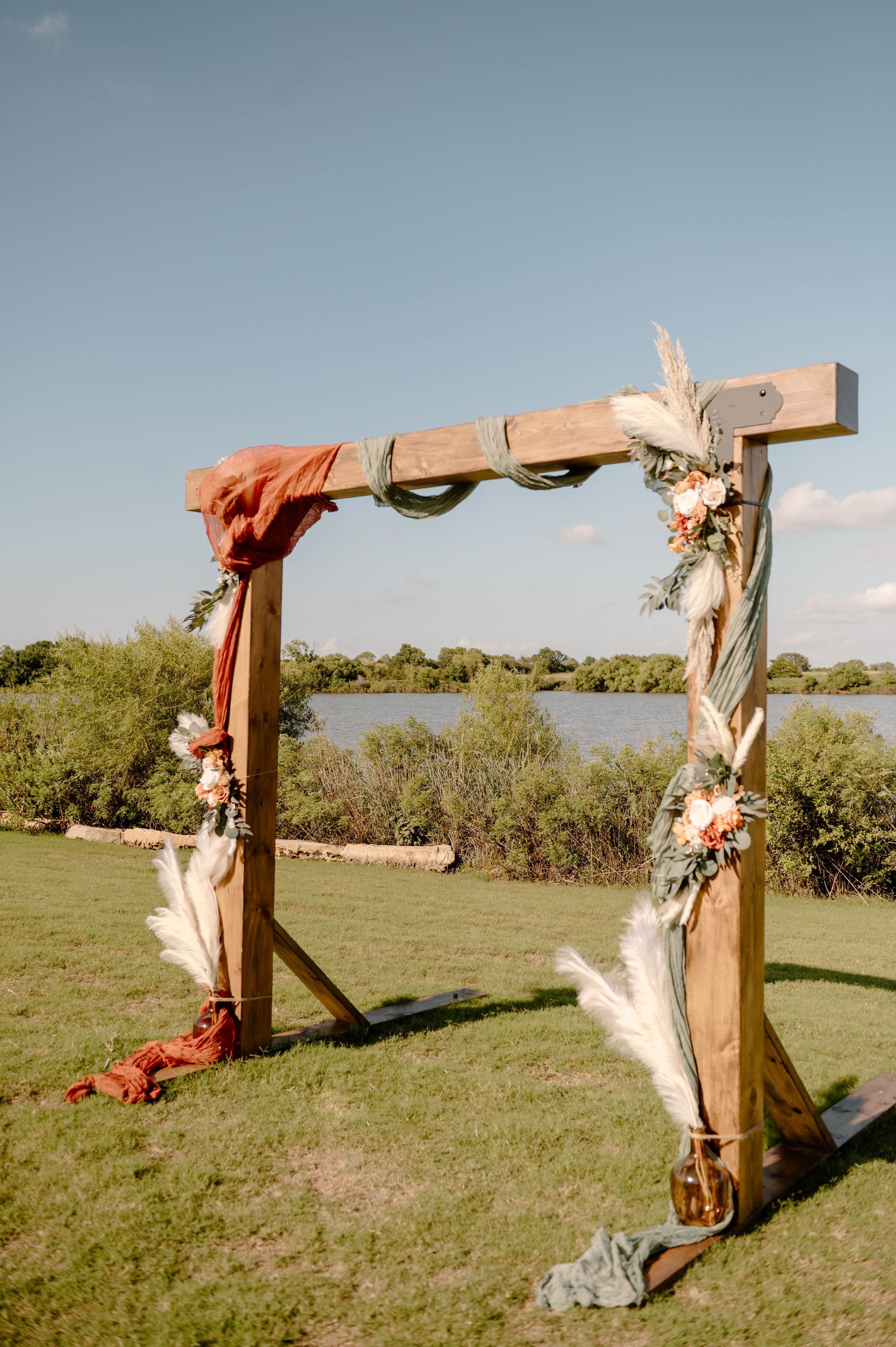 wooden wedding arch with lake in background