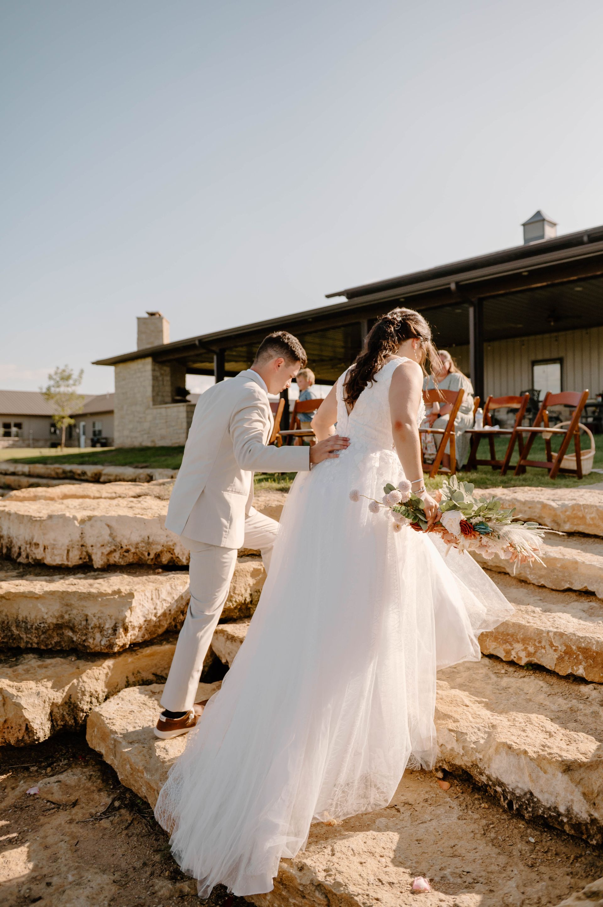 bride walking up stone steps