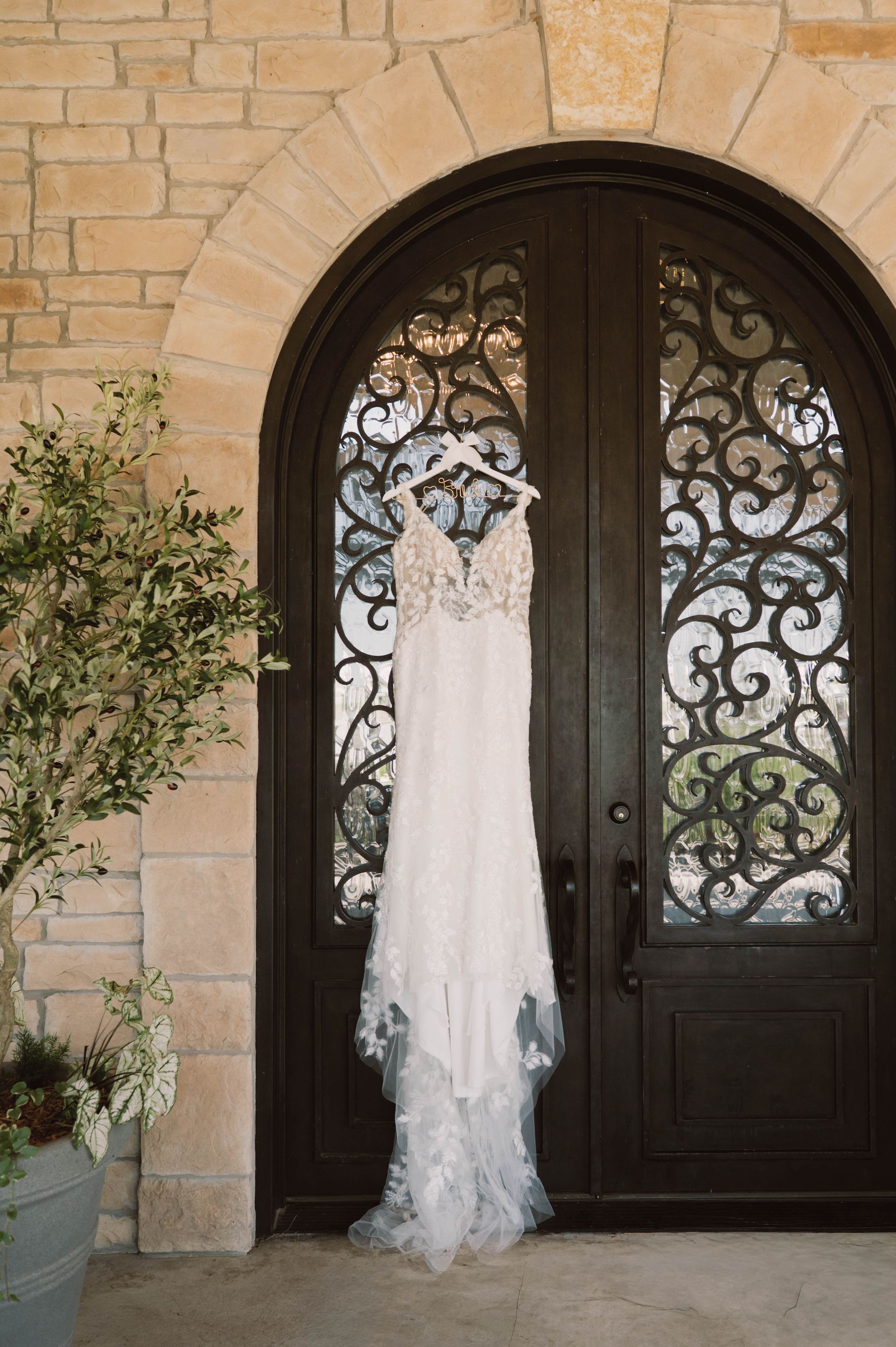 wedding gown hanging on wedding venue front door