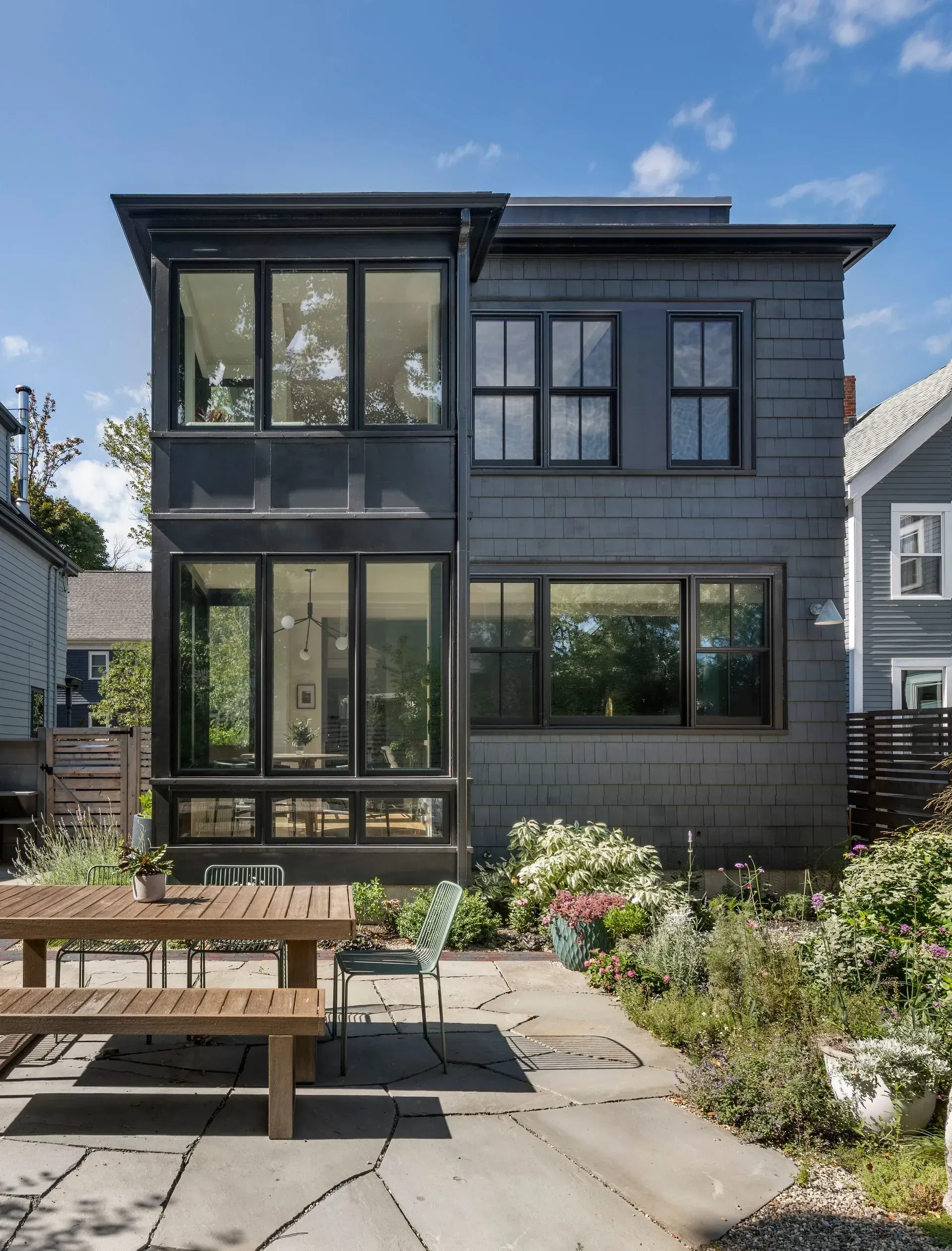 A Craftsman House recently restored, with a green backyard and wooden patio