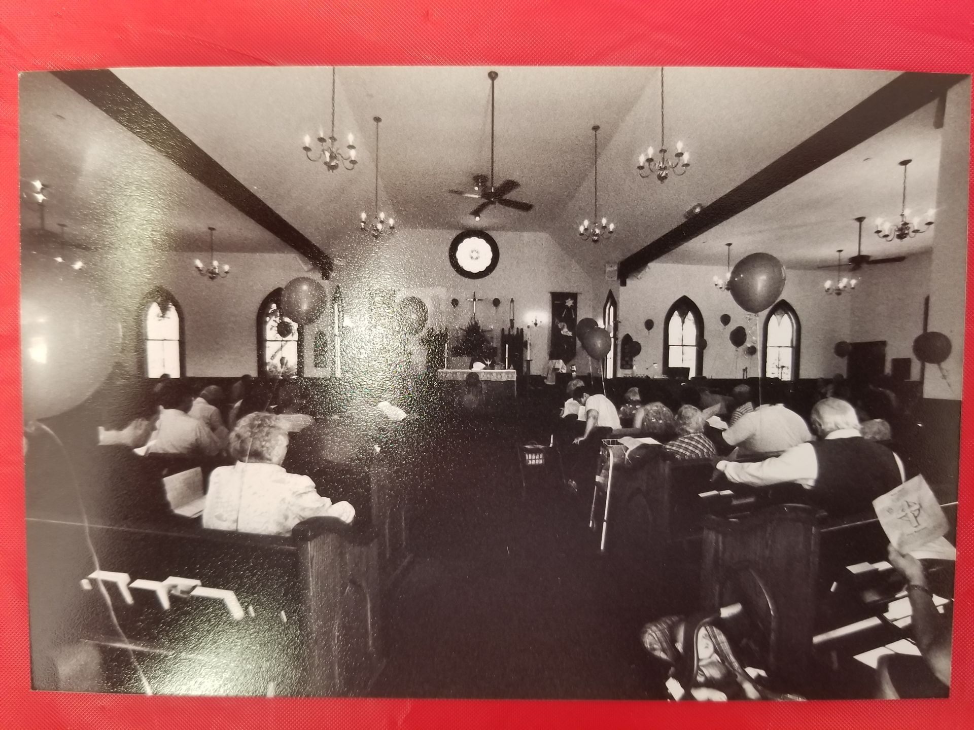 A black and white photo of people in a church