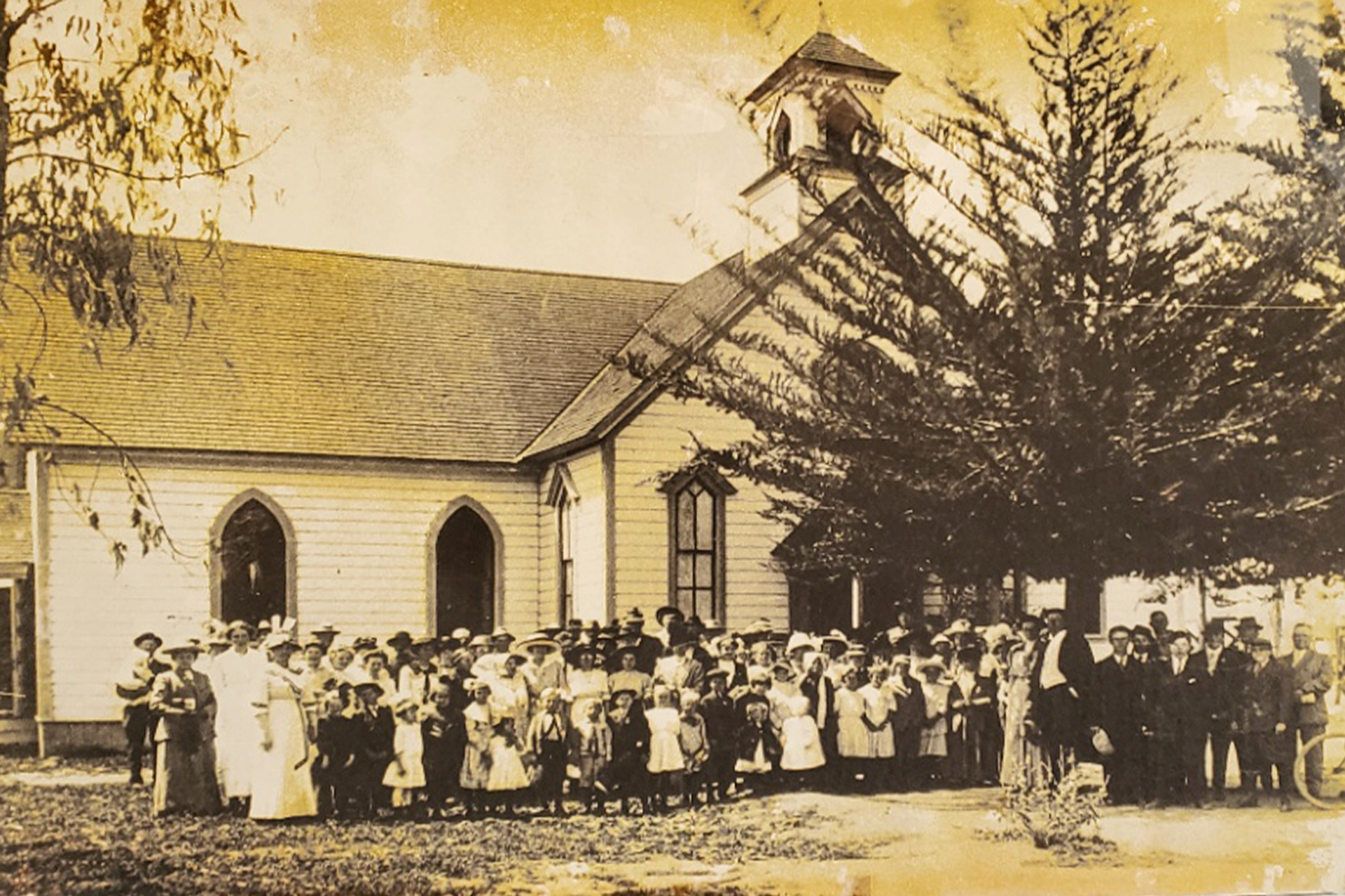 A group of people standing in front of a church