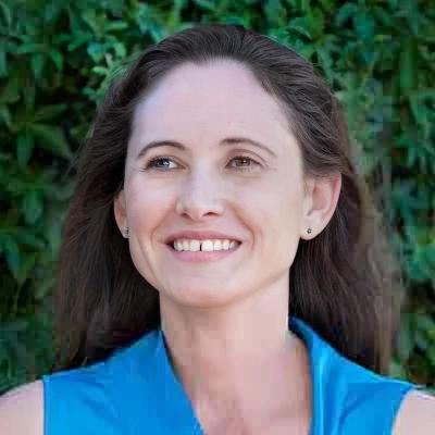 Dr Katie-Lee Elliott, Clinical Psychologist Perth smiling outdoors in blue top