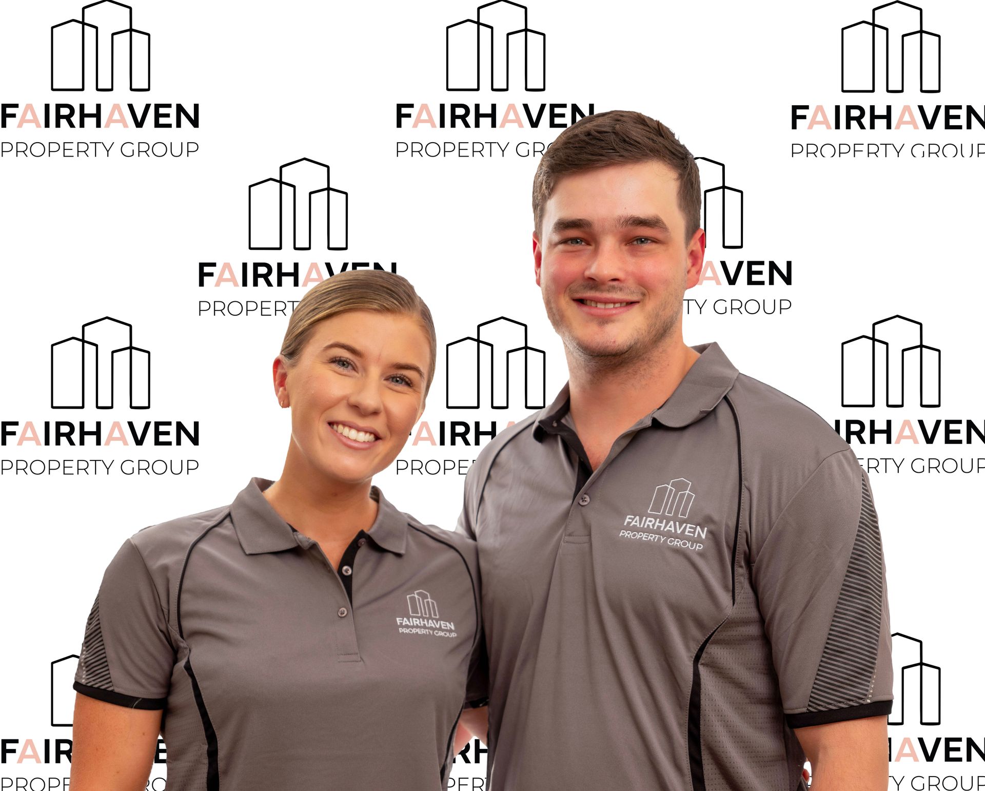 Two people in matching gray polo shirts pose in front of a logo backdrop.