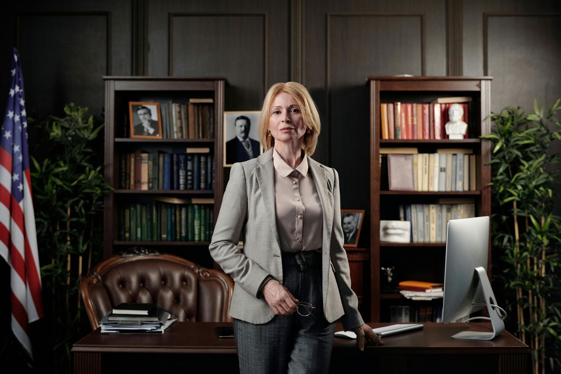 A female attorney standing in front of a desk in an office.