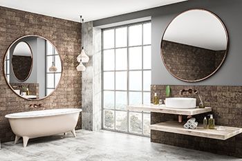 A bathroom with two sinks , a bathtub and two mirrors.