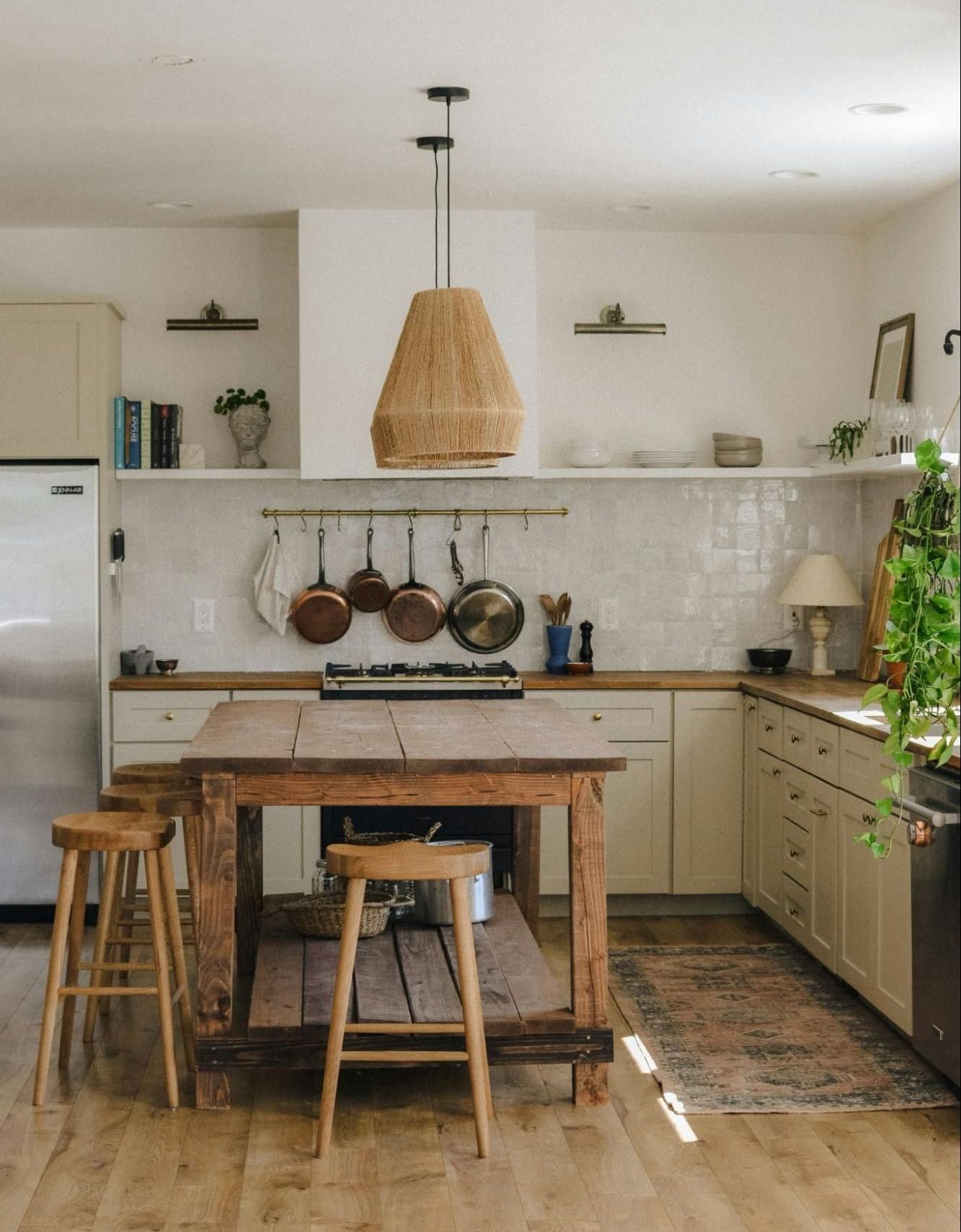 A kitchen with a wooden table and stools