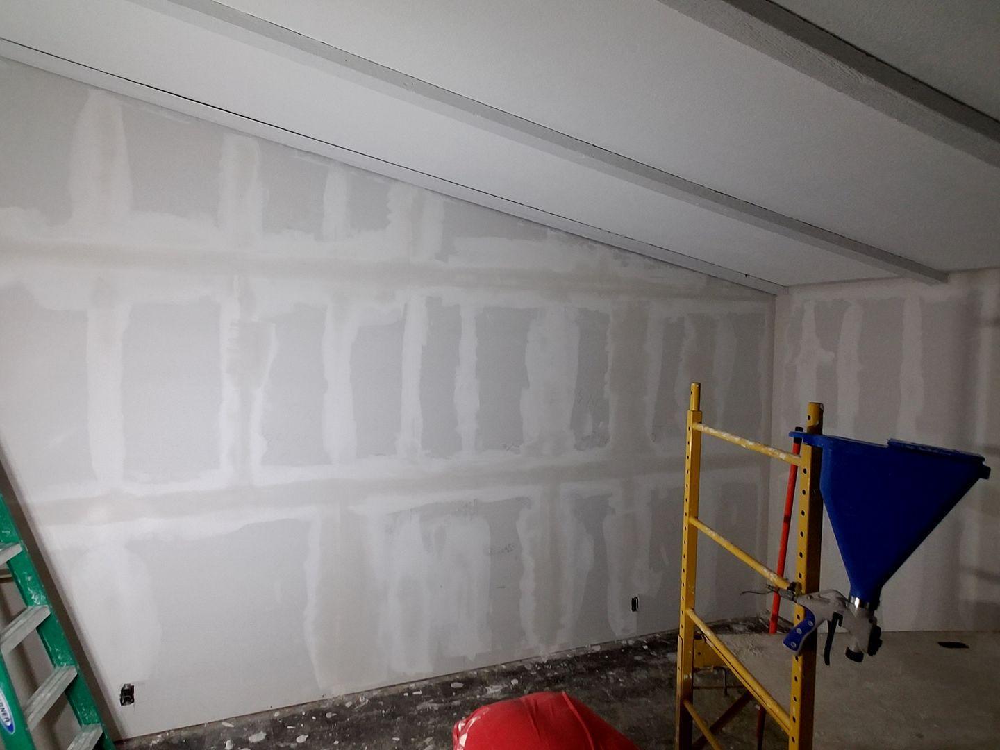A room with a ladder and a scaffolding in it.