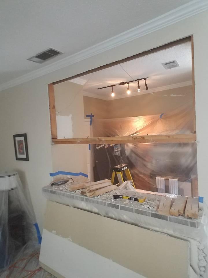 A kitchen is being remodeled with a large window.