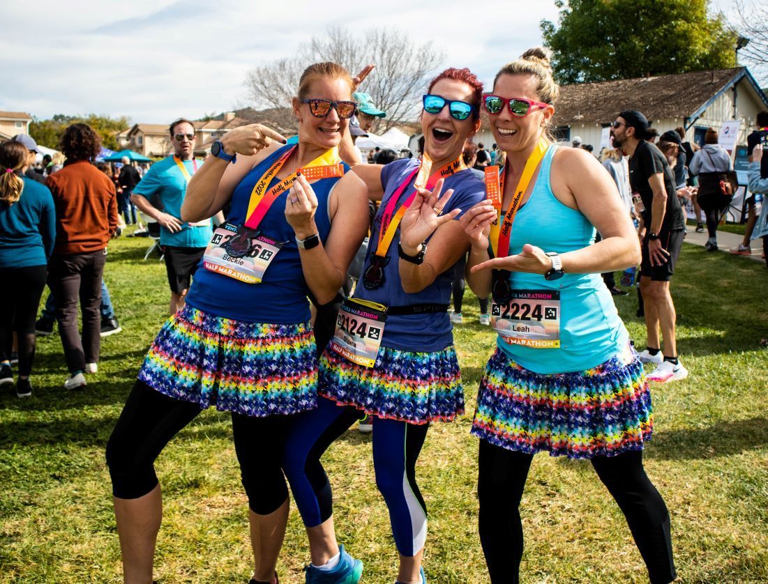Ventura Marathon - Three female runners post race medal shot.